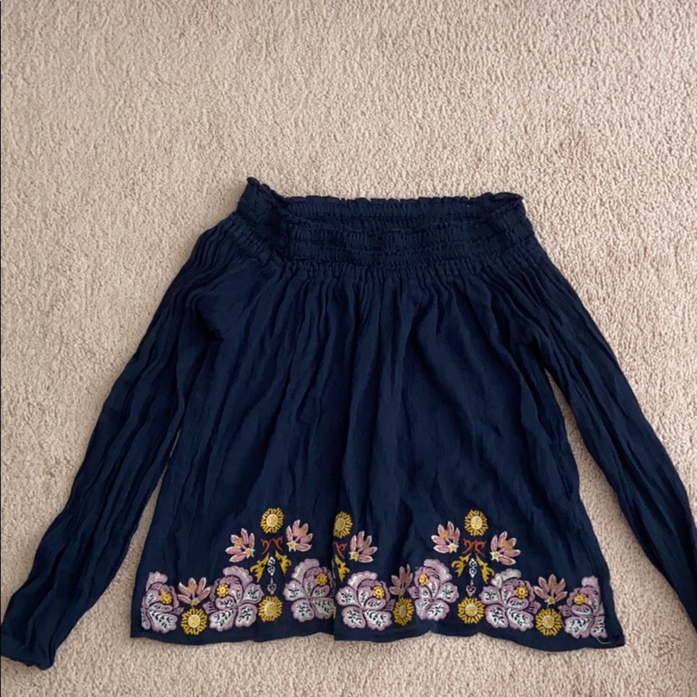 An off the shoulder dark blue top